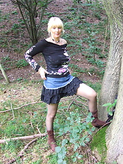 Blonde mature slut playing naked in the forest