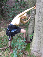 Blonde mature slut playing naked in the forest