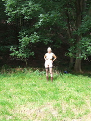 Blonde mature slut playing naked in the forest